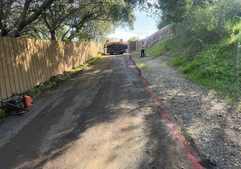Asphalt paving contractor in Columbia, SC grading a rd for an asphalt overlay.