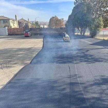 Road Construction company doing asphalt resurfacing to repair damaged parking lot in Columbia, SC.