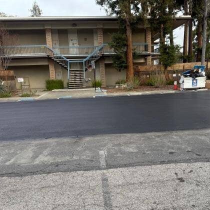 Asphalt contractors crack-filling asphalt before a sealcoating project in Columbia, SC.