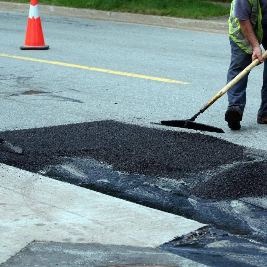 Sealcoating company near me in Columbia, SC letting sealcoat dry on a parking lot.