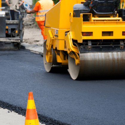 Roller operator compacting Asphalt In Columbia